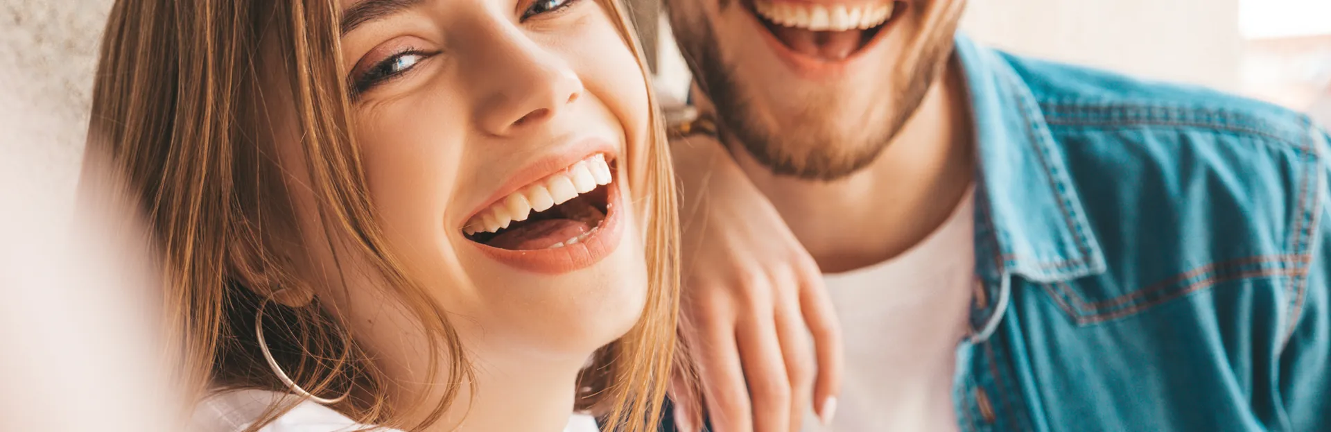 Smiling couple enjoying affordable dental care in Minneapolis