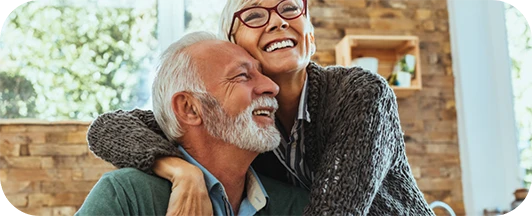 older couple laughing together at home