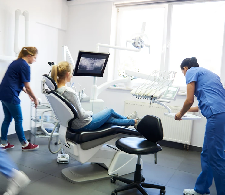 dental team caring for a patient in the operatory